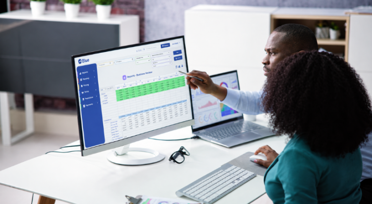 Coworkers reviewing their reporting data with Blue RGM